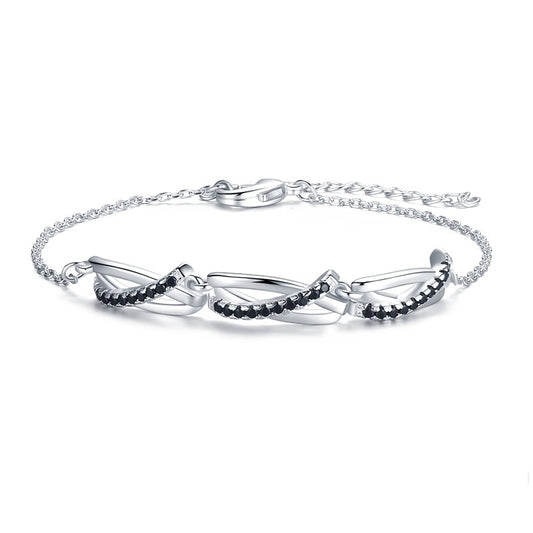 Silver bracelet with black stones on a white background
